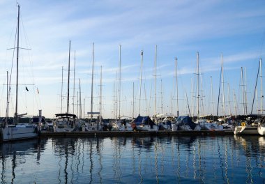 Pula, Hırvatistan, 18 Nisan 2020. Modern yatlar mavi deniz ve gökyüzünün güzel ortamında limana demirlemiş ve sıraya dizilmişti.