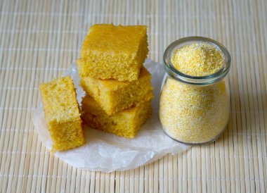 Organic polenta homemade healthy sweet snack. Four pieces of cornmeal cake clipart