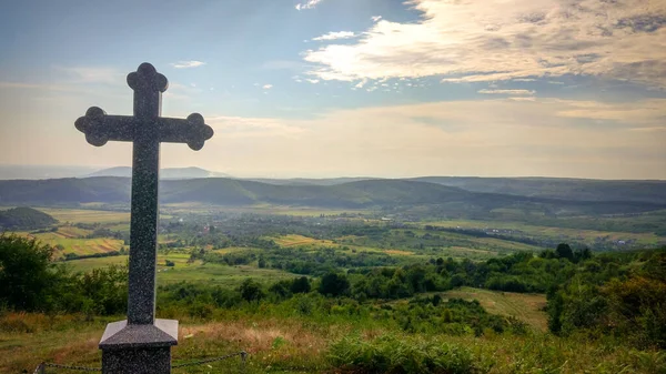 Cross on a background of countryside panorama