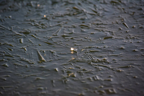 The play of the light of the sun, ice and water on a mountain river