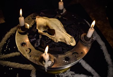 Metaphorical still life of occult symbols clipart
