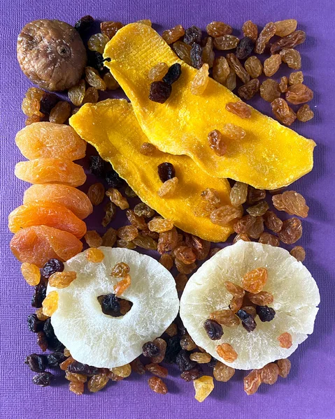 Mix of dried fruits on lilac background. Top view. Symbols of judaic holiday Tu Bishvat. Thanksgiving Day. candied fruits