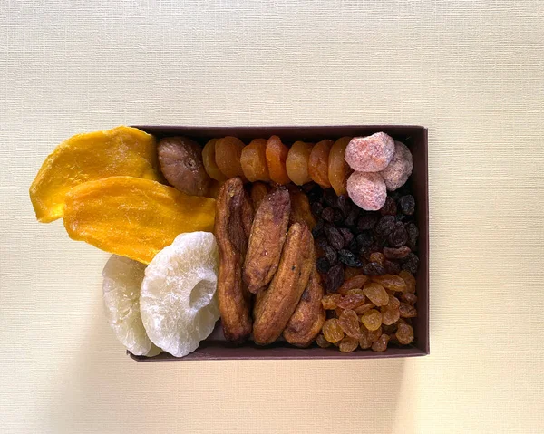 Mix of dried fruits in the box. Top view. Symbols of judaic holiday Tu Bishvat. Thanksgiving Day. candied fruits