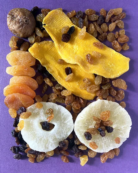 Mix of dried fruits on lilac background. Top view. Symbols of judaic holiday Tu Bishvat. Thanksgiving Day. candied fruits