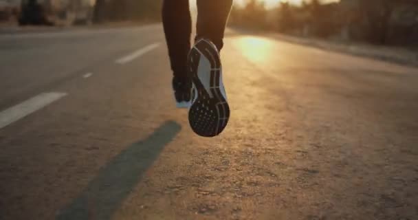 The legs are taken in close-up. Morning run. The glare of the sun. Cold weather. 4k — Stock Video