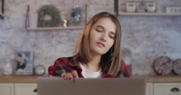 Una joven ha terminado de trabajar en un ordenador portátil y se ve agotada. 4K — Vídeos de Stock
