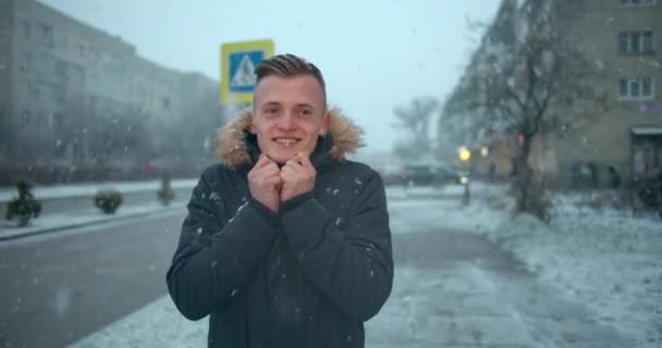 O cara está esperando lá fora na neve com geada. Inverno frio com nevasca. 4K — Vídeo de Stock