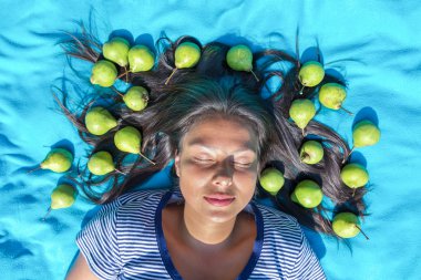 Young woman  lying eyes closed pears in black hair clipart