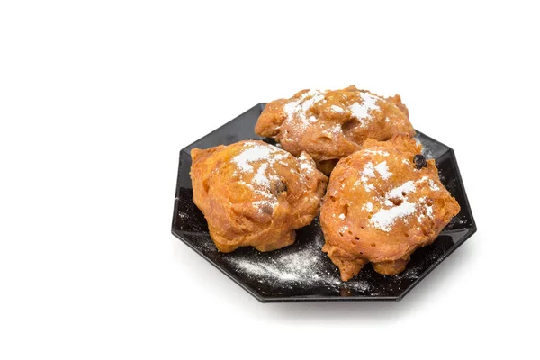 Three sugared fried fritters or oliebollen on saucer — Stock Photo, Image