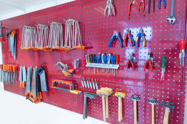 Various tools hanging at wall in high school — Stock Photo, Image