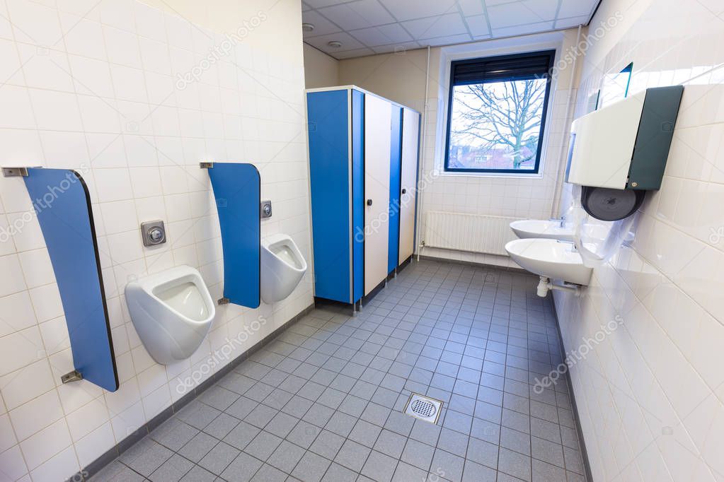 Toilet room for men with urinals sinks and towel dispenser 