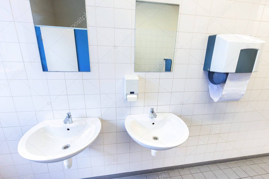 Toilet room for men with sinks and mirrors