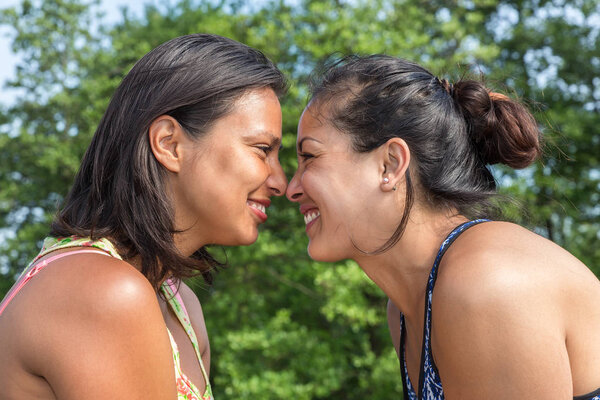 Portrait two women noses touching