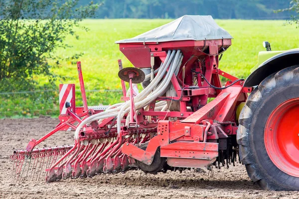 Tractor with agricultural machine on farmland