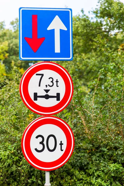 Traffic signs near bridge in nature — Stock Photo, Image