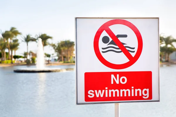 No swimming sign near water of pond in Egypt — Stock Image Swimming Sign Water Pond Egypt Royalty Free Stock Photos