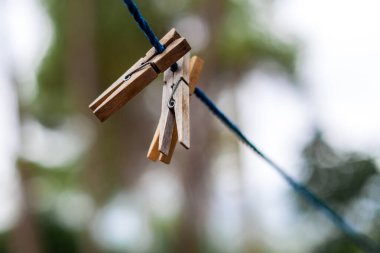 Ahşap elbise askıları mavi bir ipte.