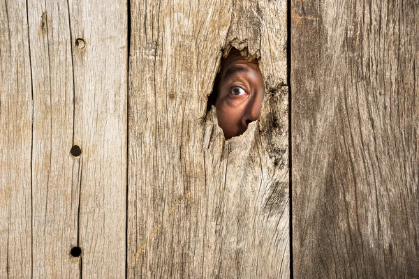 The eye in wooden hole — Stock Photo, Image