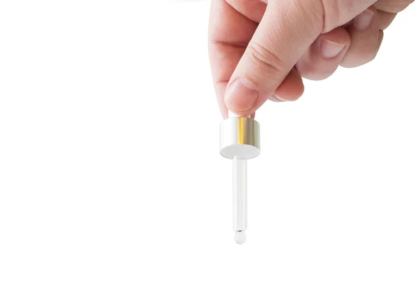 Hand holding a medicine pipette — Stock Photo, Image