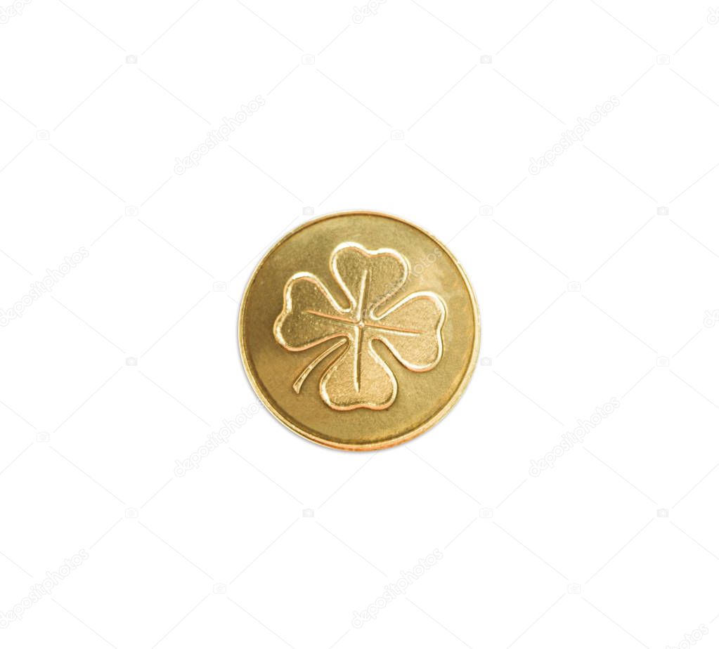 Golden coin with four leaf clover