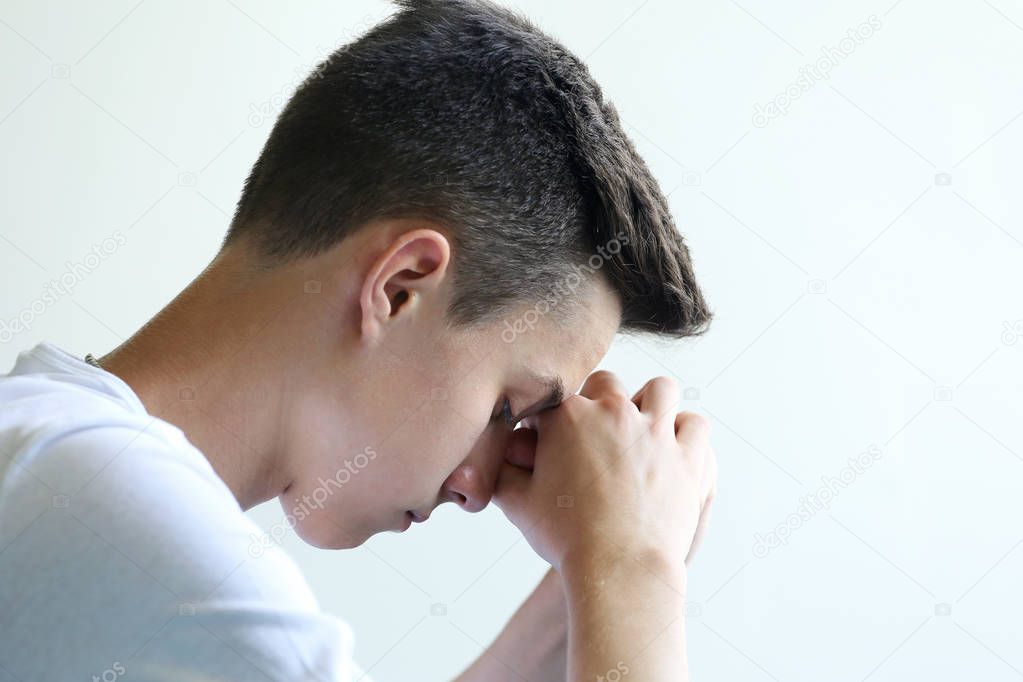 Young man thoughtful and sad face