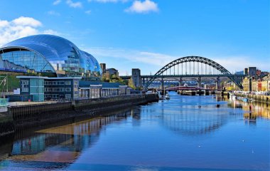 There are some fantastic reflective views of a wide range of contemporary and diverse architecture, along the River Brew, at Gateshead, in Newcastle Upon Tyne, England. clipart