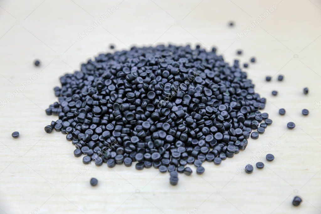 Close-up of plastic polymer granules. Polymer pellets on Wooden 