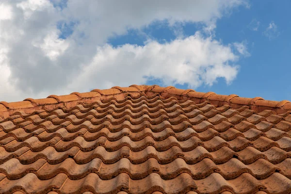 Roof top on sky background. Close up of brown clay roof tiles. R Stock Photo