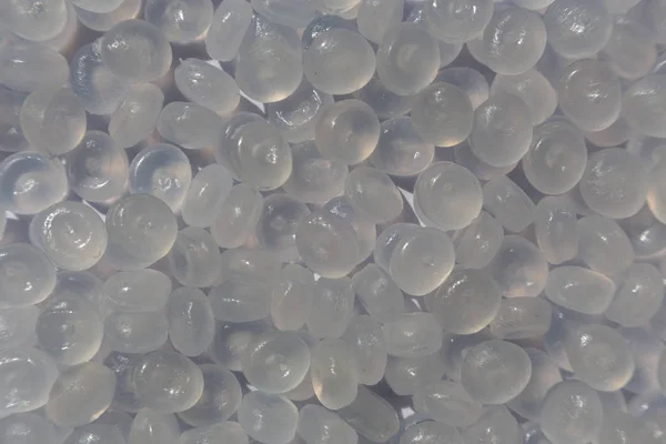 Close-up of plastic polymer granules. hand hold Polymer pellets.