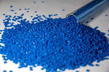 Close-up of plastic polymer granules. hand hold Polymer pellets. clipart