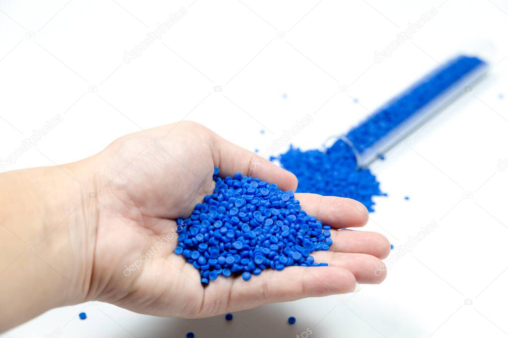 Close-up of plastic polymer granules. hand hold Polymer pellets. polymer plastic. compound polymer.