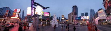 Toronto, Ontario, Canada-26 December 2019: Panoramic view of a Yonge-Dundas Square at Christmas, a public square that hosts many public events, performances and art displays, establishing itself as a prominent landmark in Toronto clipart