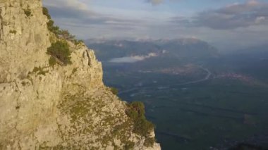 Swiss Alps. Aerial View of Residental Valley and Steep Cliff on Golden Hour