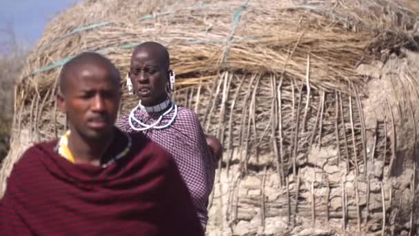 Maasai African Tribe Woman Carrying Baby on Back in Front of Man, Slowmotion — Stock Video