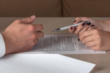 Hands of contractual parties, a woman and a man, signing a contract clipart