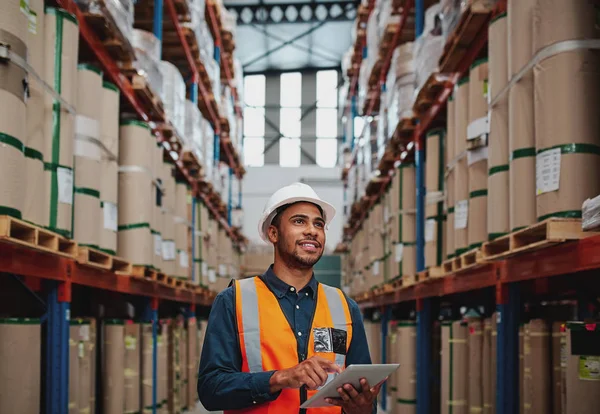 Handsome Warehouse Worker uses Digital Tablet for Checking Stock, On the shelves Standing Cardboard Boxes — Stock fotografie