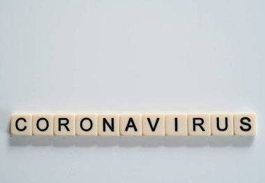 Coronavirus covid19 spelt on tiles with copy space above 