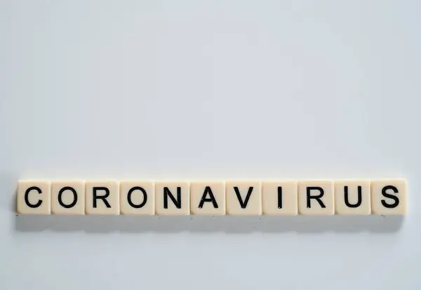 Coronavirus covid19 spelt on tiles with copy space above — Stockfoto
