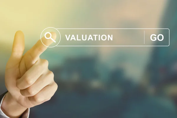 Business hand clicking valuation button on search toolbar — Stock Photo, Image