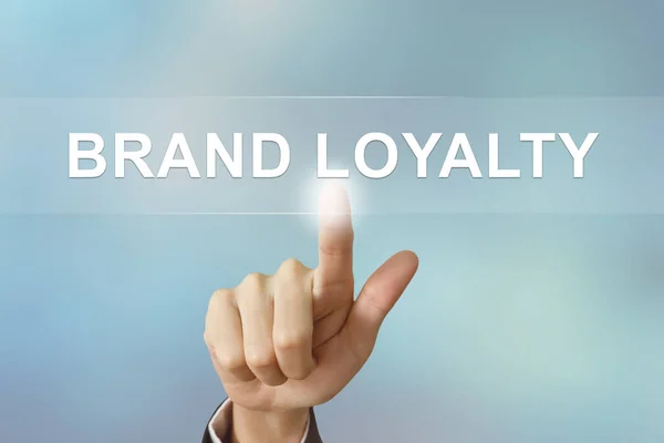 Business hand clicking brand loyalty button — Stock Photo, Image