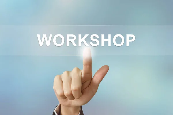 Business hand clicking workshop button on blurred background — Stock Photo, Image