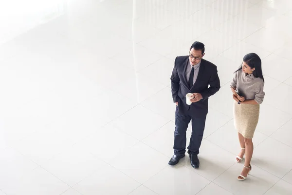 Asian business people, man and woman, talking about ideas Royalty Free Stock Photos