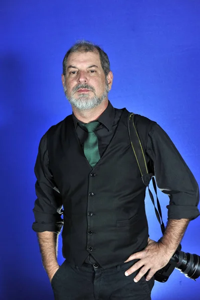 adult man with white beard on blue background