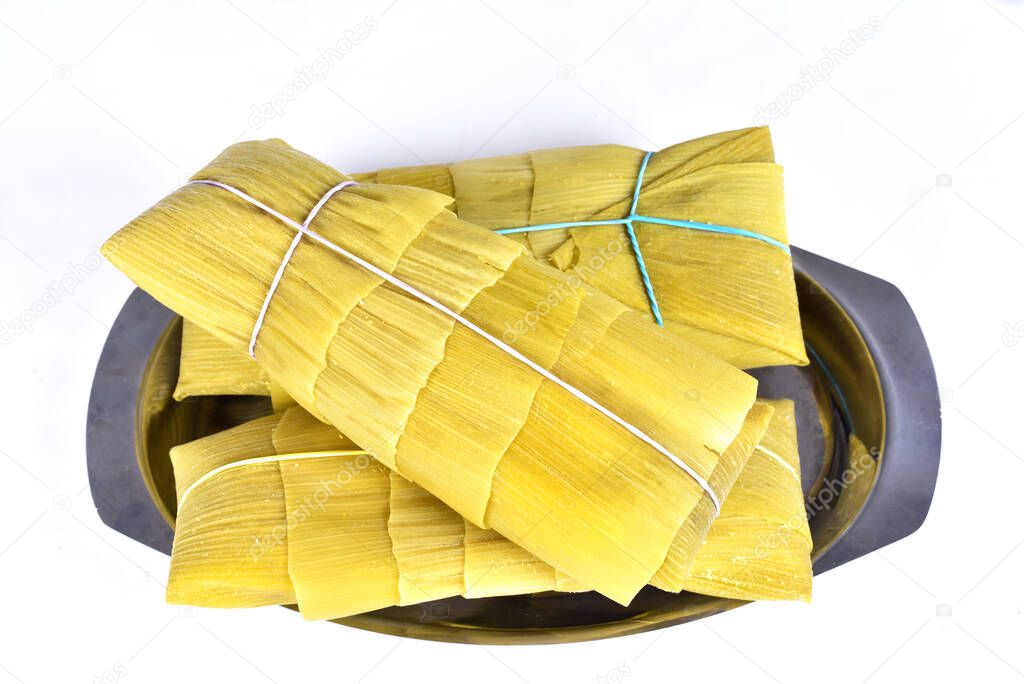 pamonha, corn mush, traditional corn cake culinary brazilian food, top view on white background