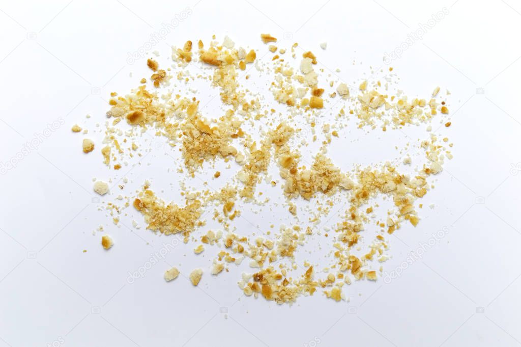 Scattered crumbs of cookies on white background.