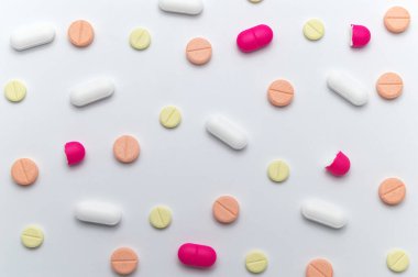 Beyaz arka planda tedavi ve sağlık hizmetleri için farklı renkli ilaçlar veya ilaç hapları.