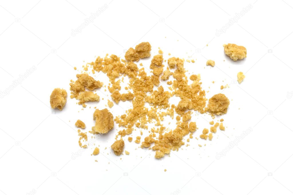 Scattered crumbs of butter cookies on white background.