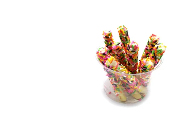 Snack Biscuit Sticks Coated Rainbow Sugar Plastic Glass Isolated White — Stock Photo, Image