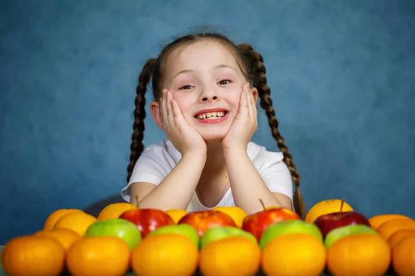 Little girl in white T-shirt love fruit