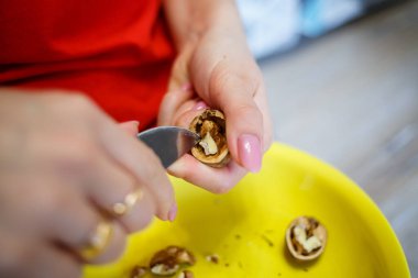 Kız kabuktaki cevizleri soyar..